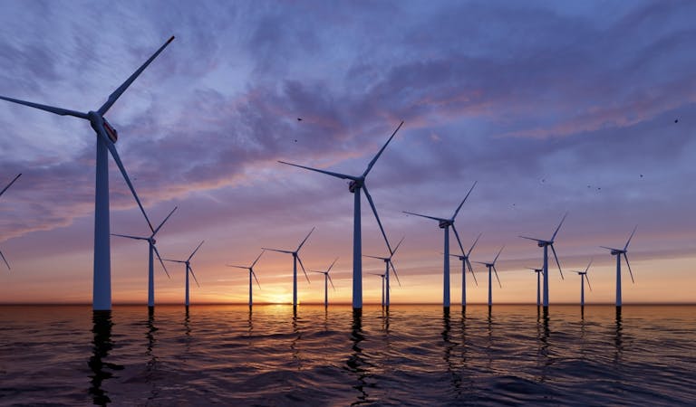 Offshore Wind Turbines Farm at sunset