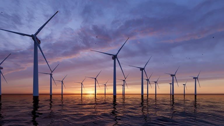 Offshore Wind Turbines Farm at sunset